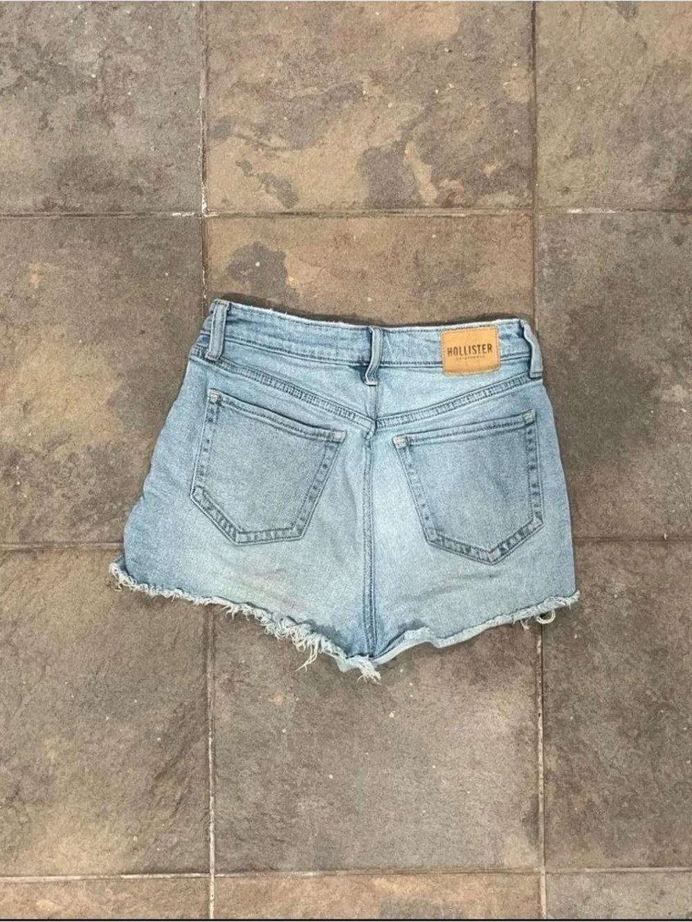 Light blue denim shorts with frayed hem